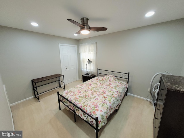 bedroom featuring light colored carpet and ceiling fan