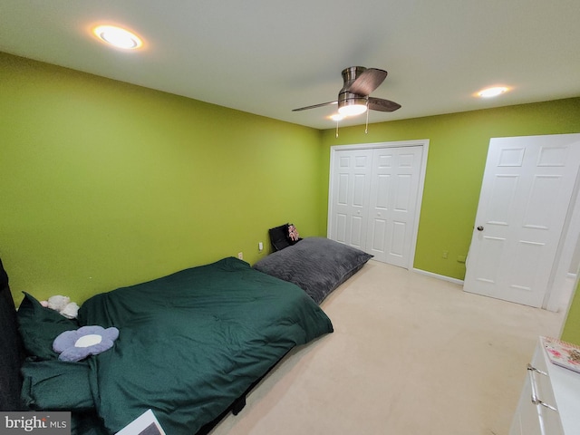 bedroom with ceiling fan, carpet, and a closet