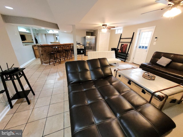 tiled living room featuring ceiling fan