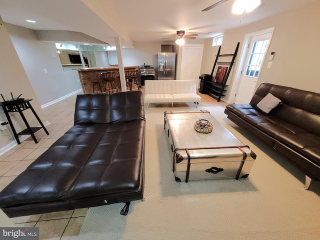 tiled living room featuring ceiling fan