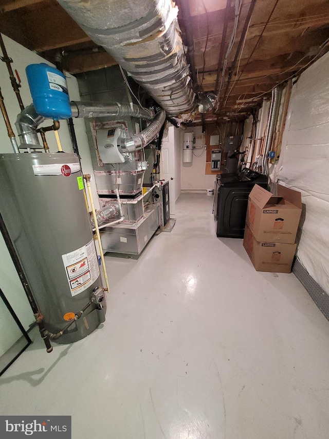 basement featuring water heater and washer / clothes dryer