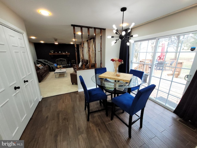 dining space featuring an inviting chandelier and dark hardwood / wood-style flooring