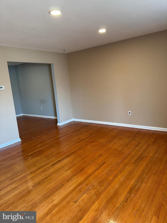 spare room featuring wood-type flooring