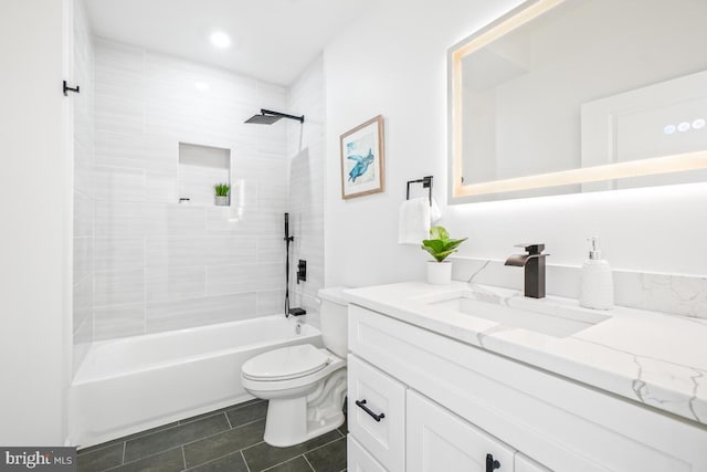 full bathroom with tiled shower / bath, vanity, toilet, and tile patterned flooring