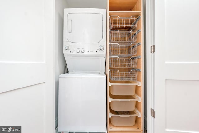 laundry room with stacked washer / dryer