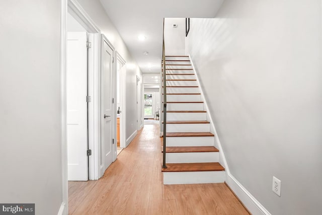 stairway featuring wood-type flooring