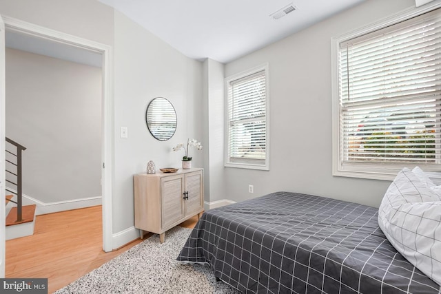 bedroom with hardwood / wood-style flooring