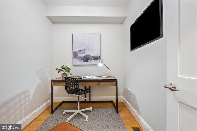 office with light hardwood / wood-style floors