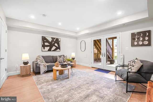 living room featuring light hardwood / wood-style flooring and french doors