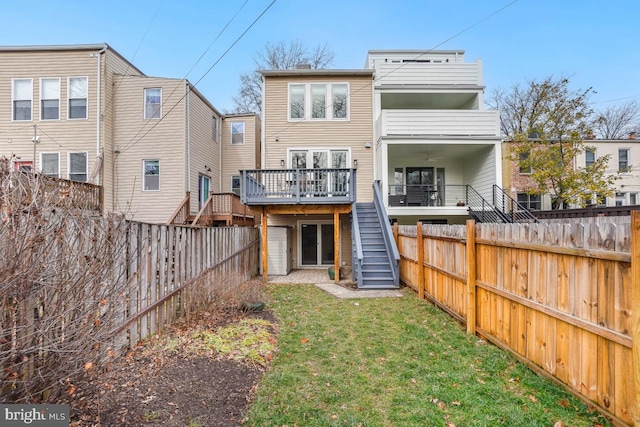 back of house featuring a wooden deck, central AC, and a lawn