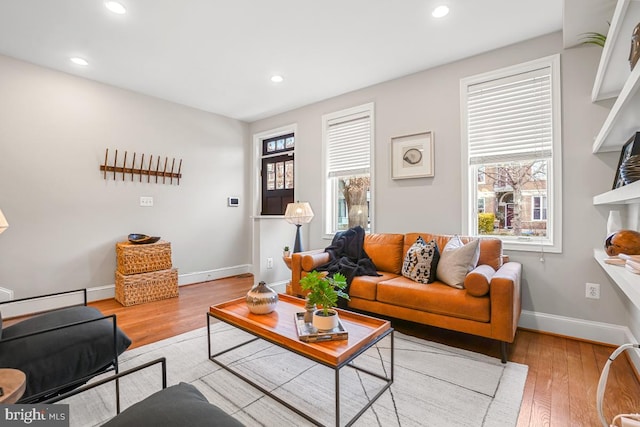 living room with a healthy amount of sunlight and light hardwood / wood-style floors