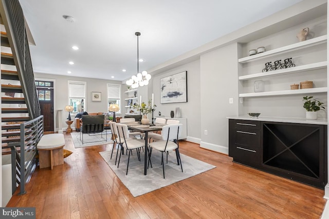 dining area featuring a notable chandelier and light hardwood / wood-style floors