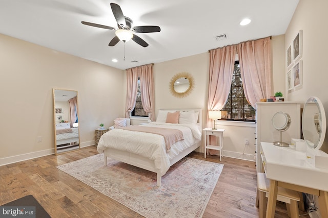 bedroom with ceiling fan and light wood-type flooring