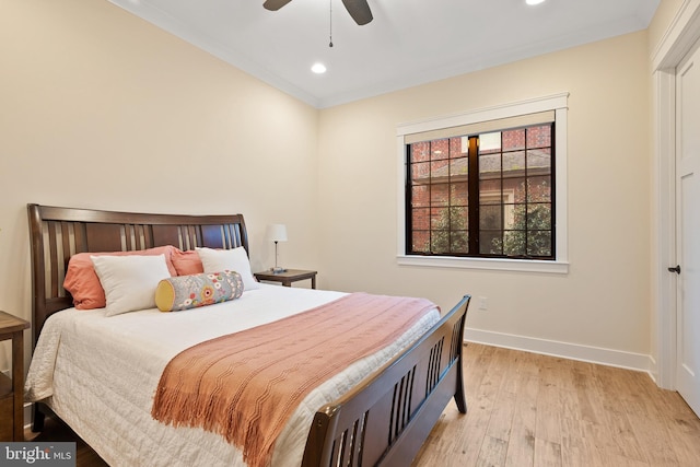 bedroom with ceiling fan, ornamental molding, and light hardwood / wood-style floors