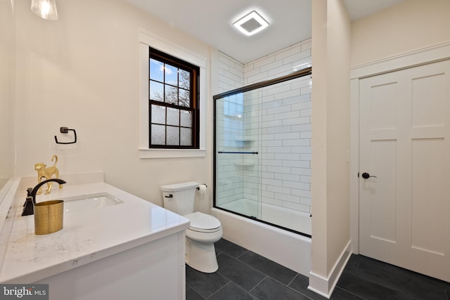 full bathroom featuring vanity, tile patterned flooring, enclosed tub / shower combo, and toilet