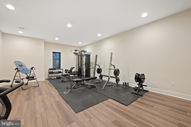 workout area with hardwood / wood-style flooring