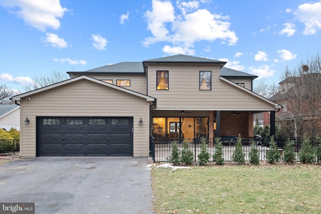front facade featuring a garage and a front lawn