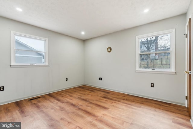 unfurnished room featuring hardwood / wood-style flooring