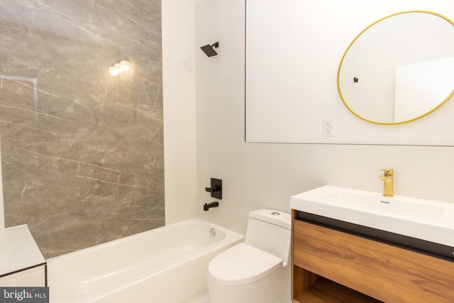 full bath featuring toilet, shower / bath combination, vanity, and tile walls