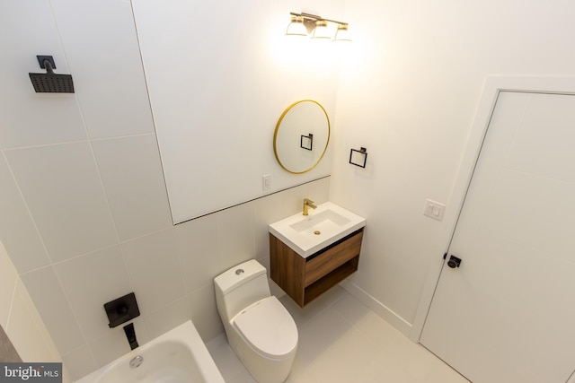 bathroom with tile walls, vanity, and toilet