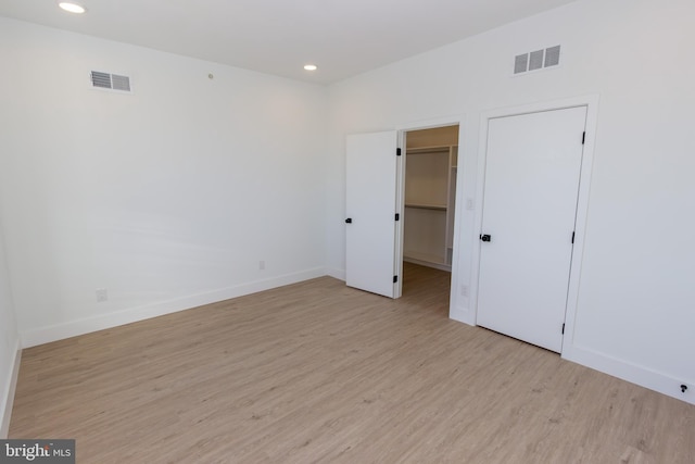 unfurnished bedroom with light wood-style floors, recessed lighting, visible vents, and baseboards