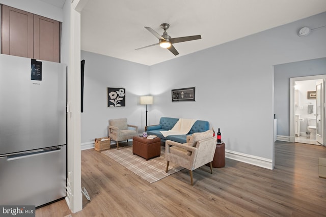 living room with ceiling fan and light wood-type flooring