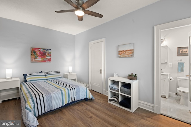 bedroom featuring dark wood-type flooring, connected bathroom, and ceiling fan