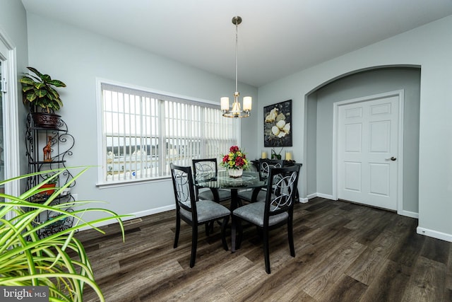 dining room featuring dark wood-type flooring and a notable chandelier