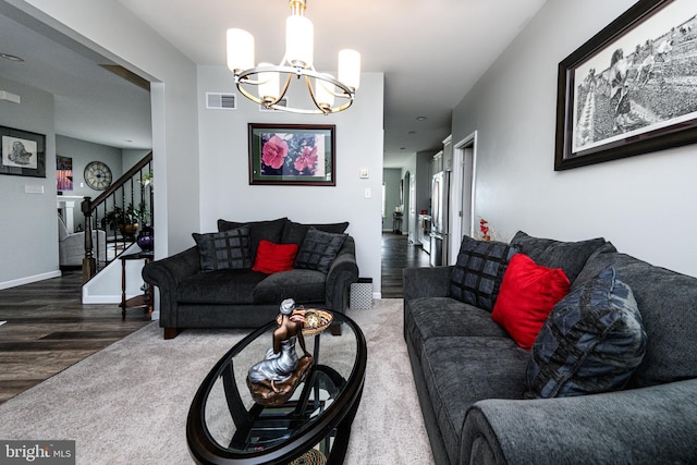 living room with an inviting chandelier and dark hardwood / wood-style flooring