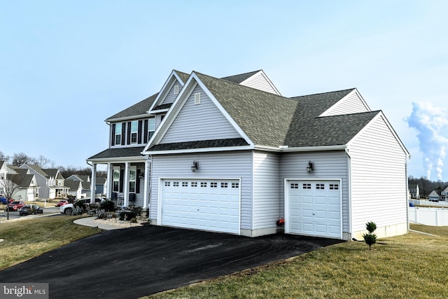 view of side of property with a garage and a yard