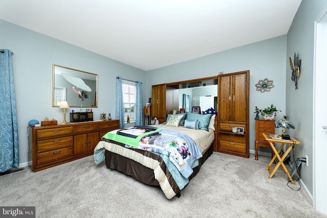 bedroom featuring light colored carpet