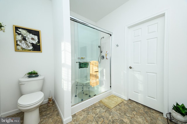 bathroom featuring an enclosed shower and toilet