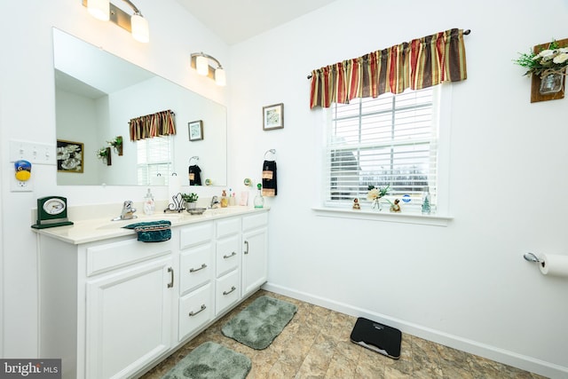 bathroom featuring a healthy amount of sunlight and vanity