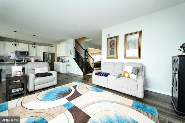 living room with dark hardwood / wood-style flooring and sink