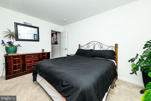 bedroom featuring light colored carpet