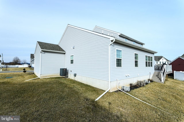 view of home's exterior with a yard and cooling unit