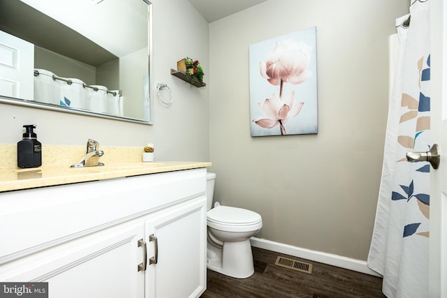 bathroom featuring hardwood / wood-style flooring, vanity, and toilet