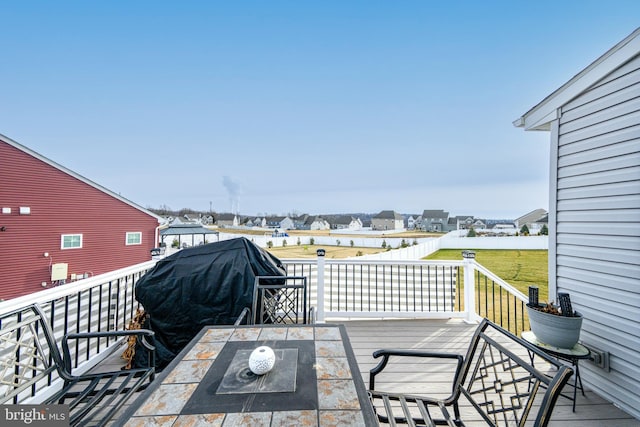 wooden deck featuring a yard