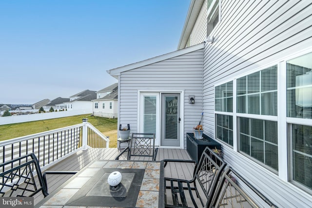 wooden deck featuring a yard