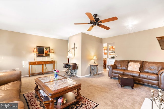 living room featuring light colored carpet and ceiling fan