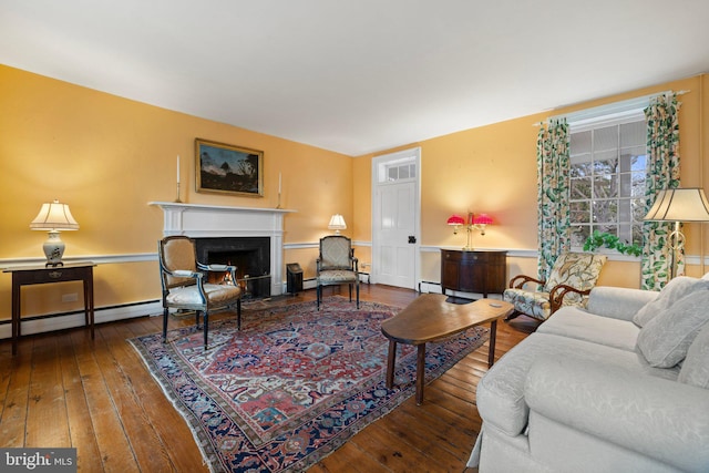 living room featuring wood-type flooring and a baseboard heating unit