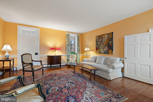 living room featuring dark hardwood / wood-style flooring and baseboard heating