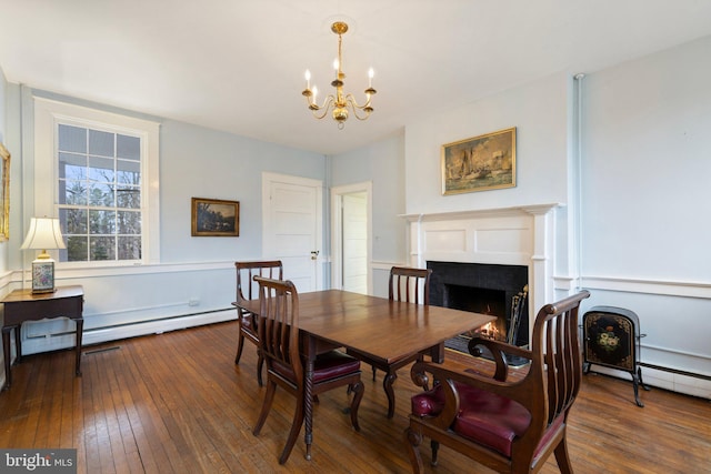 dining space with a chandelier, dark hardwood / wood-style flooring, and baseboard heating