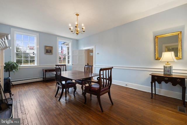 dining room with an inviting chandelier, a baseboard radiator, and dark hardwood / wood-style flooring