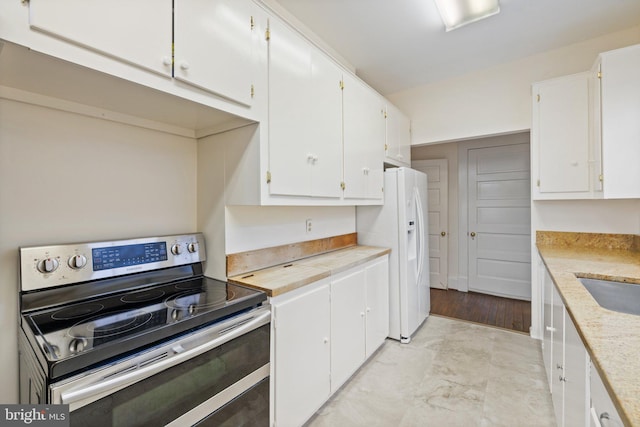 kitchen with white cabinetry, stainless steel electric range oven, sink, and white fridge with ice dispenser