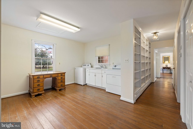 interior space with hardwood / wood-style flooring, a baseboard radiator, washer / clothes dryer, and sink