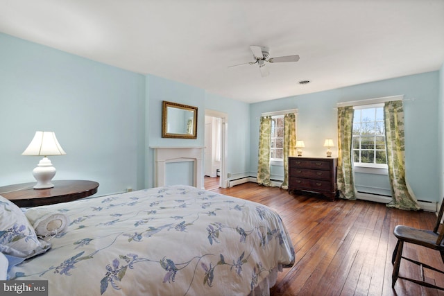 bedroom with wood-type flooring, ceiling fan, and a baseboard radiator