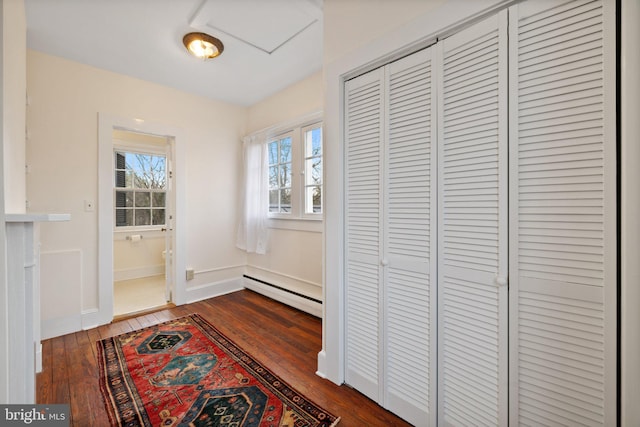 doorway featuring dark hardwood / wood-style flooring and a baseboard heating unit