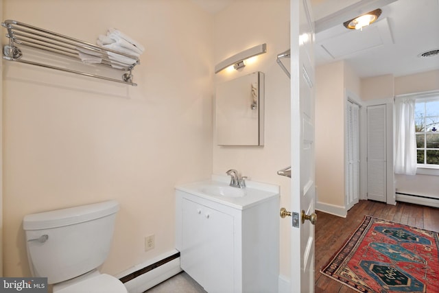 bathroom featuring vanity, hardwood / wood-style flooring, a baseboard radiator, and toilet