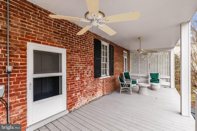 wooden deck featuring ceiling fan